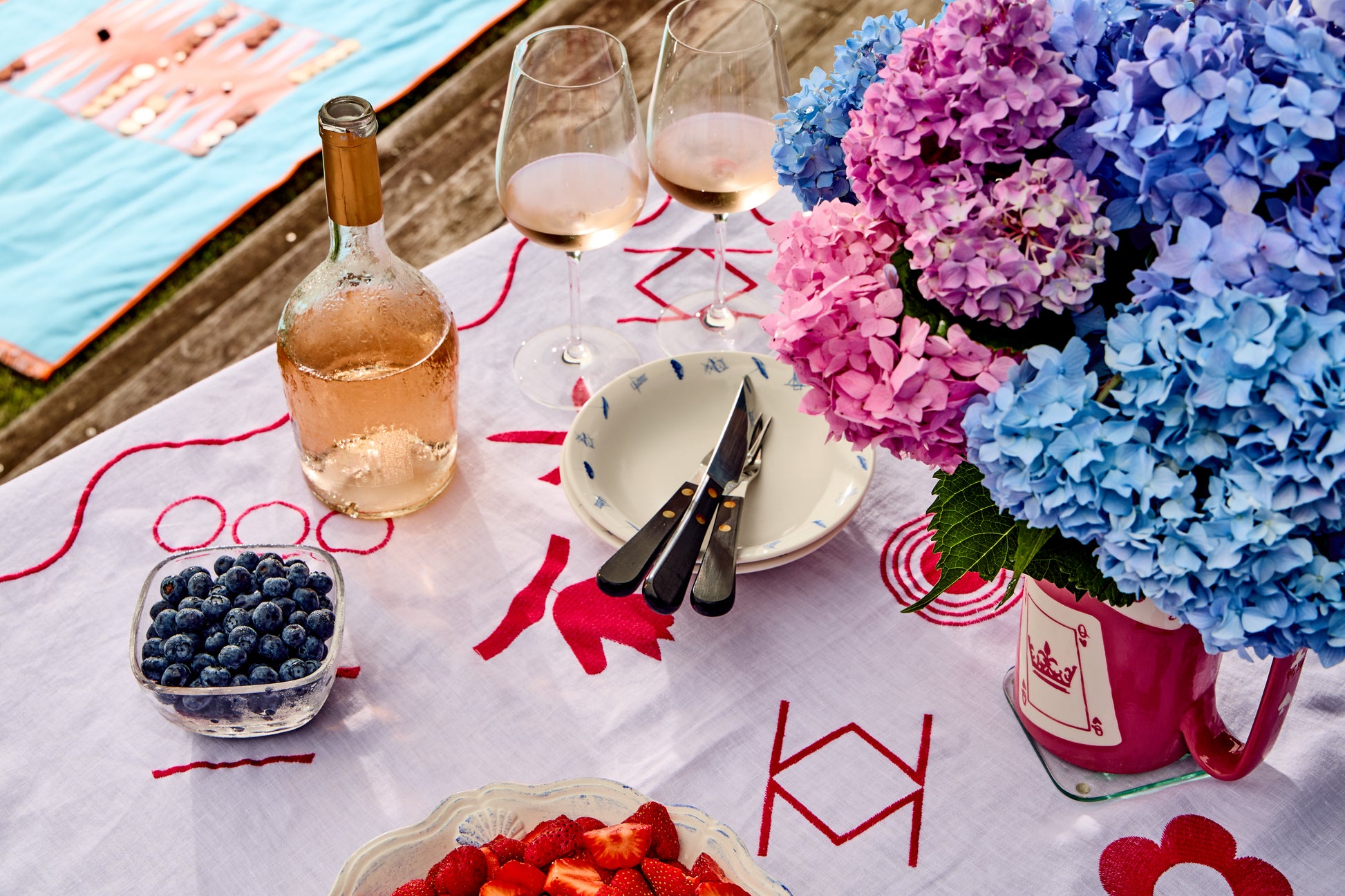 Close up of table set with fruit and wine - mahjong linen tablecloth
