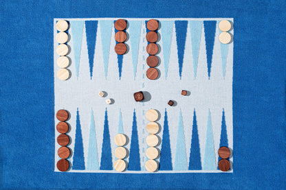 close up of terry backgammon board with wood pieces, set and ready for play