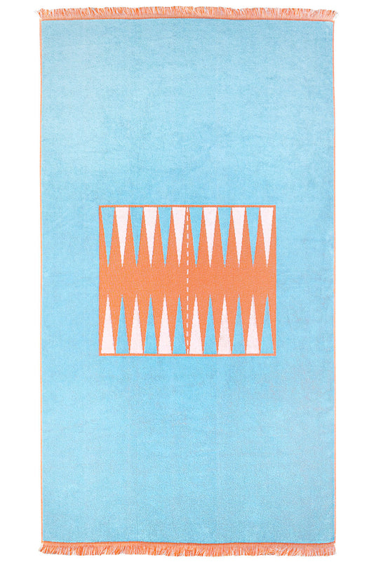 Full head on photograph of The Beach Board, blue and orange backgammon board woven into thick terry cloth with fringe border