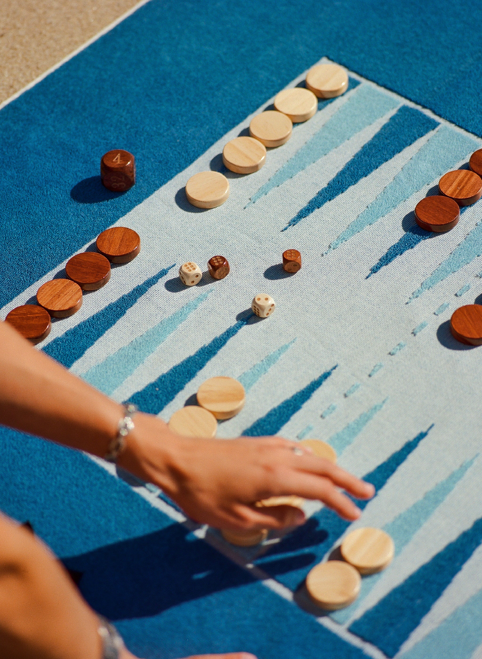 Close up of the beach board, a premium terry towel with backgammon woven into it